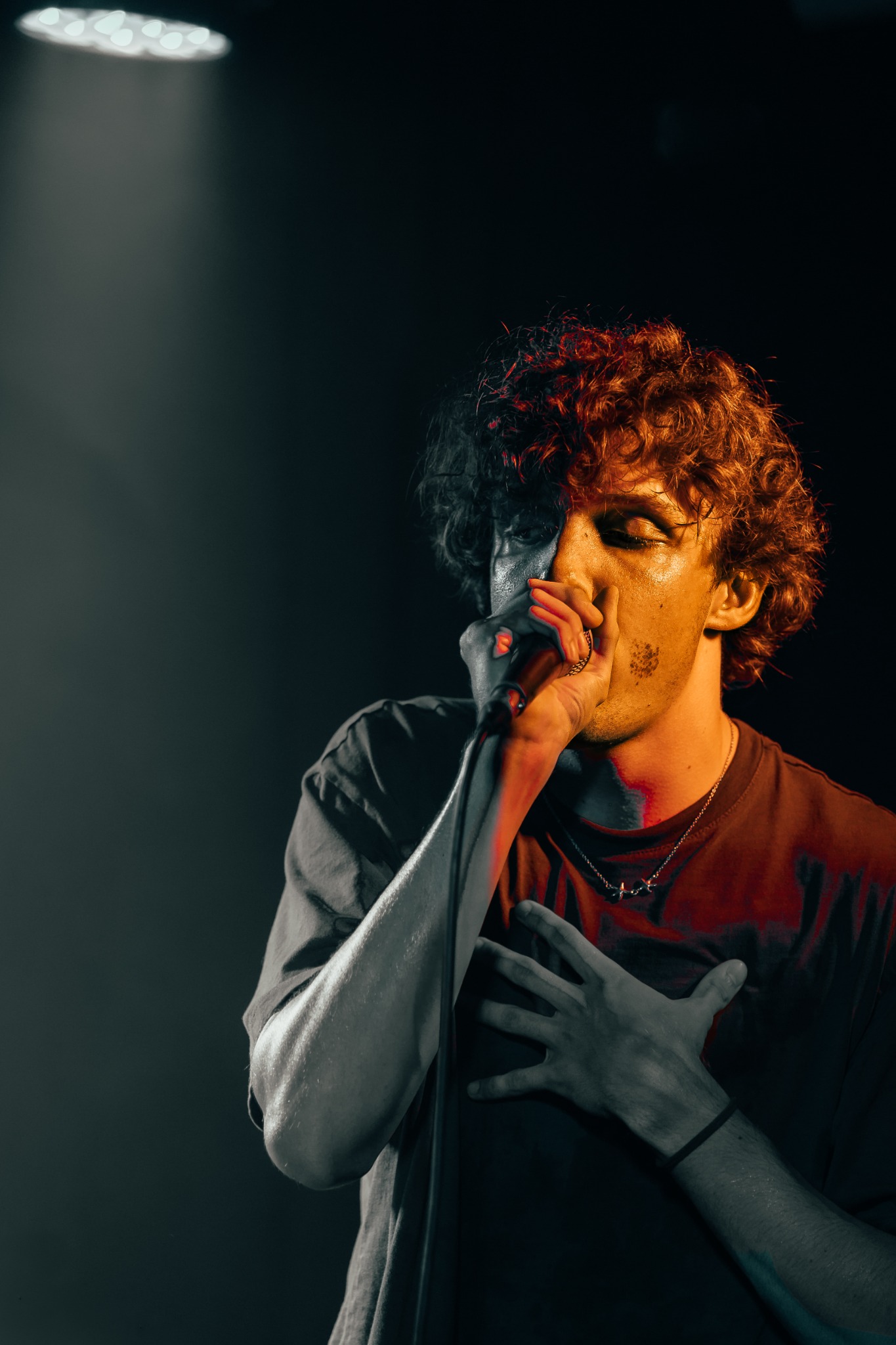 Chanteur baigné d’une lumière grise et orange